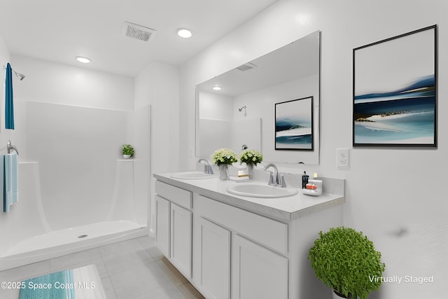 bathroom featuring tile patterned floors, vanity, and walk in shower