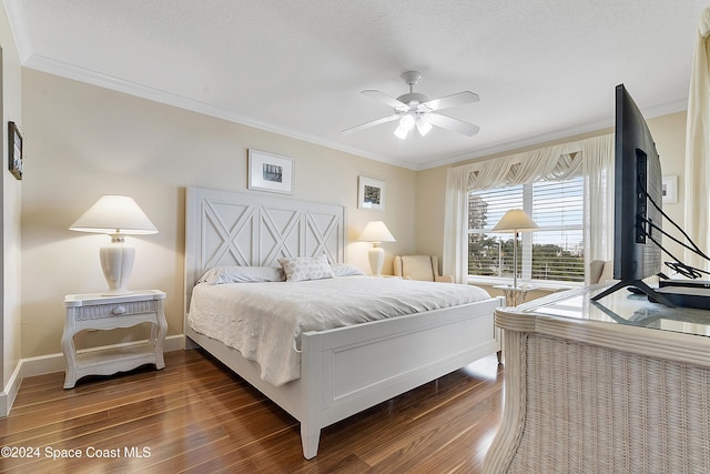 bedroom featuring a textured ceiling, ceiling fan, dark hardwood / wood-style floors, and crown molding