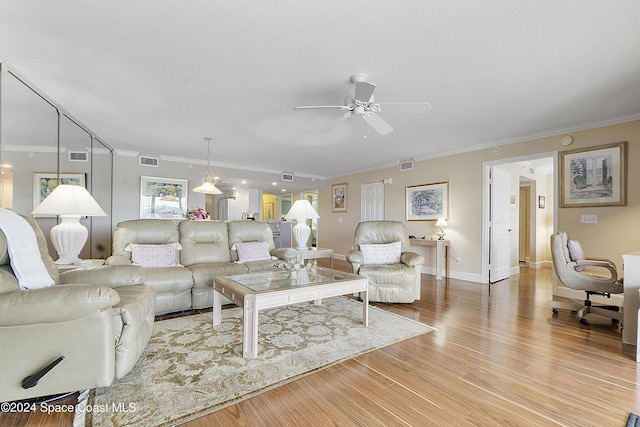 living room featuring light hardwood / wood-style floors, ceiling fan, and crown molding