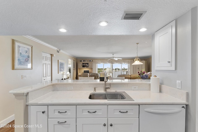 kitchen featuring ceiling fan, sink, white cabinets, and a textured ceiling