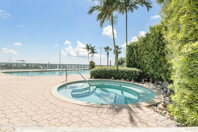 view of swimming pool featuring a community hot tub