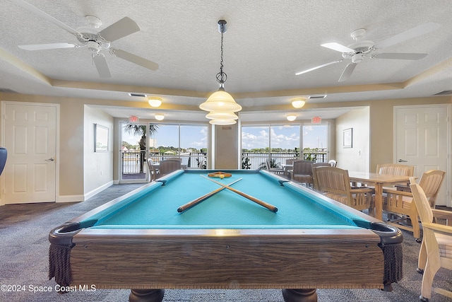 recreation room featuring a tray ceiling, ceiling fan, and pool table