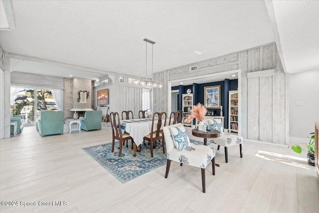 dining room featuring a textured ceiling and light hardwood / wood-style flooring