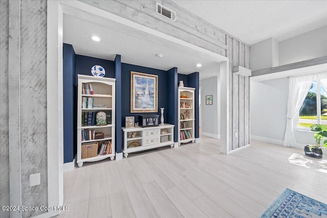 living room featuring hardwood / wood-style floors and a textured ceiling