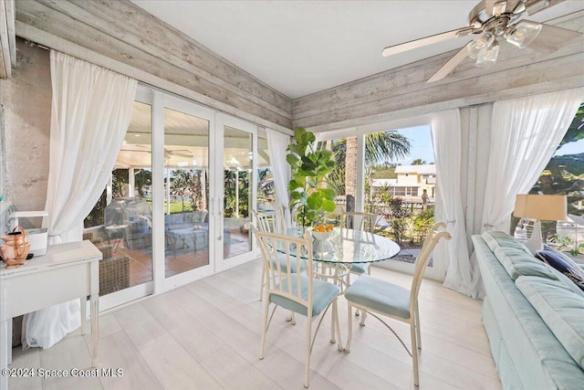 sunroom / solarium featuring ceiling fan