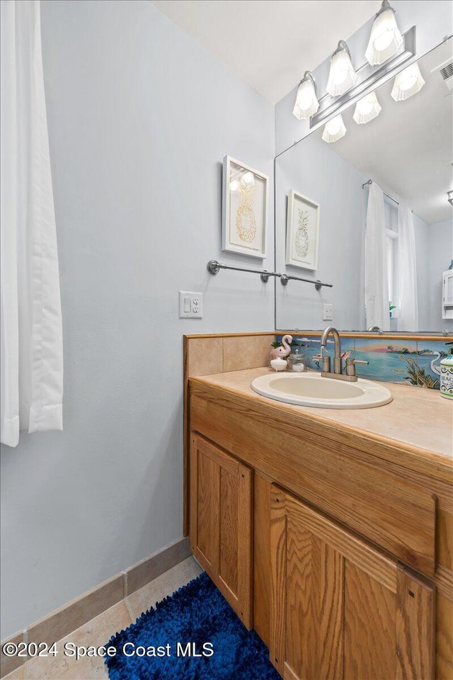 bathroom featuring tile patterned flooring and vanity