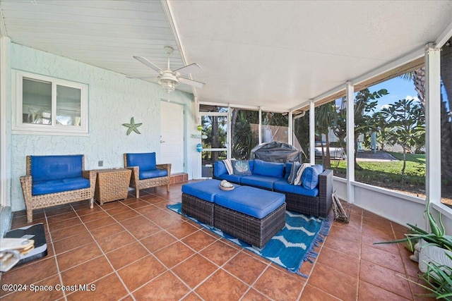 sunroom / solarium featuring ceiling fan