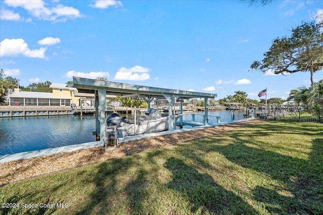 dock area with a water view and a lawn