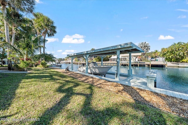 dock area featuring a lawn and a water view