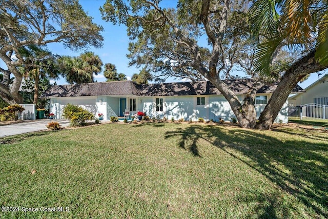 ranch-style home featuring a garage and a front yard