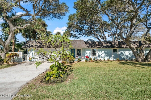 ranch-style home with a front lawn and a garage