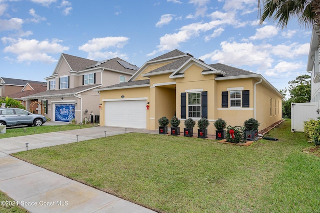 view of front of property featuring a garage and a front lawn