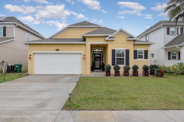 view of front of home featuring a garage and a front lawn