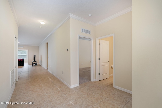 hall with light tile patterned floors and ornamental molding