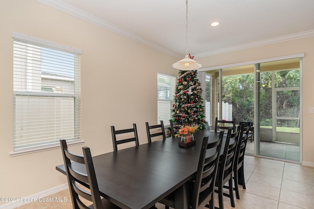 tiled dining room featuring ornamental molding