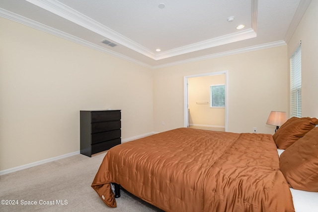 bedroom with a raised ceiling, crown molding, and light carpet