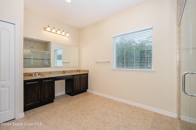 bathroom with tile patterned flooring, vanity, and a shower with shower door