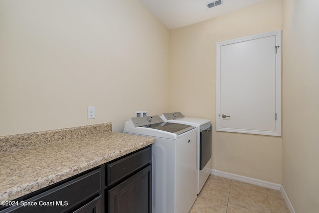 laundry room featuring separate washer and dryer and light tile patterned floors