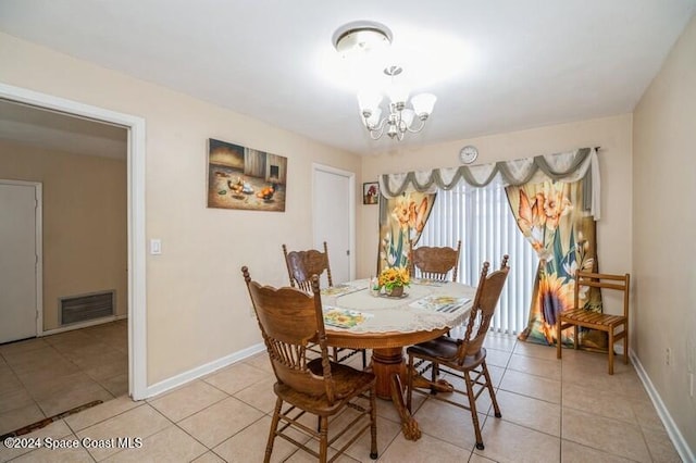 tiled dining area with a chandelier