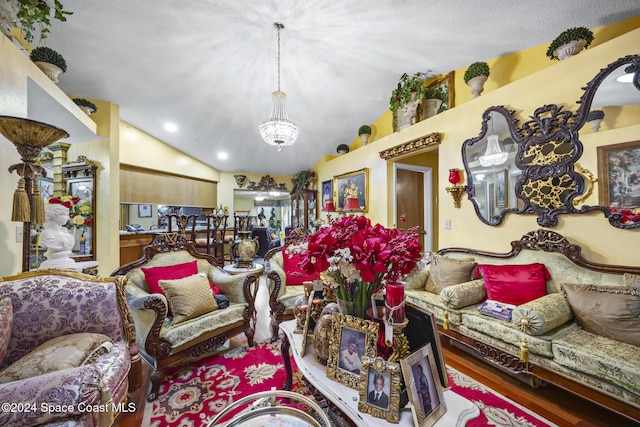 living room with hardwood / wood-style flooring, lofted ceiling, and a notable chandelier