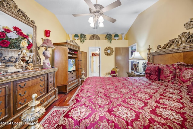 bedroom with dark hardwood / wood-style flooring, vaulted ceiling, and ceiling fan