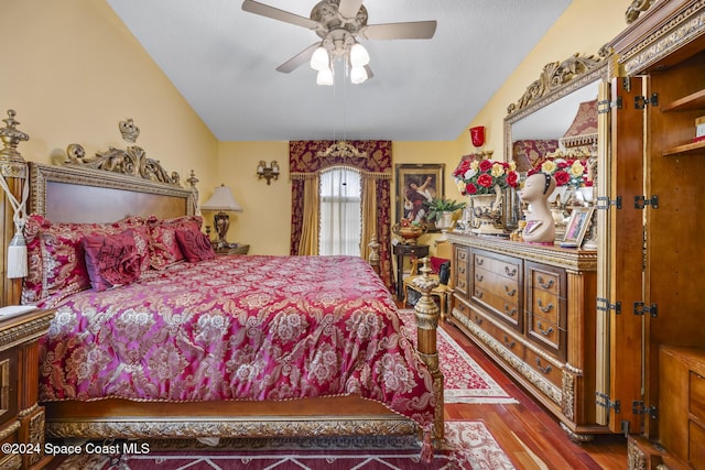 bedroom with hardwood / wood-style flooring, ceiling fan, and vaulted ceiling