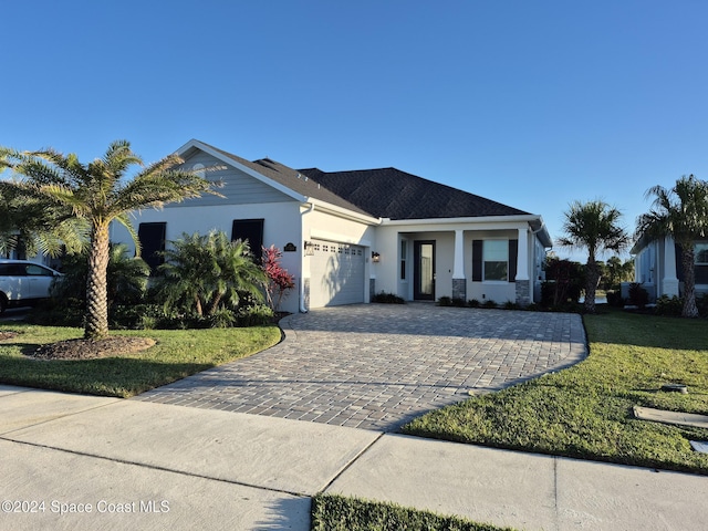 view of front of property with a front lawn and a garage