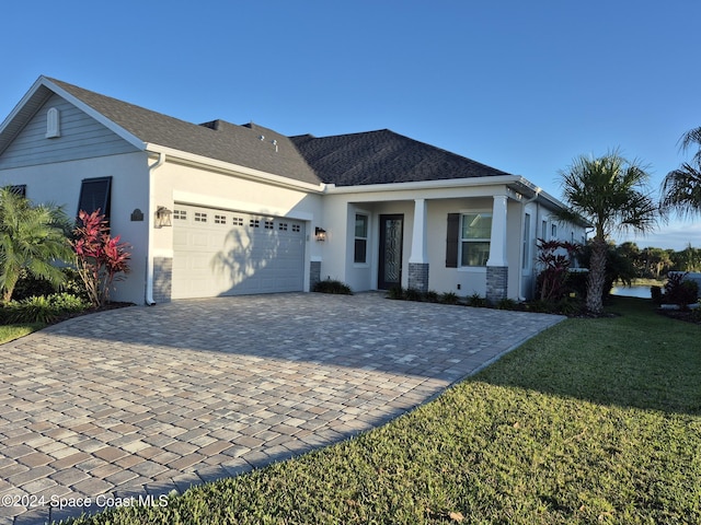 view of front of house with a garage and a front lawn