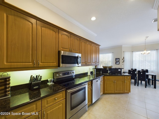 kitchen with appliances with stainless steel finishes, ornamental molding, sink, a notable chandelier, and light tile patterned flooring