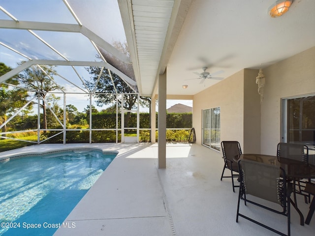 view of swimming pool featuring a lanai, ceiling fan, and a patio