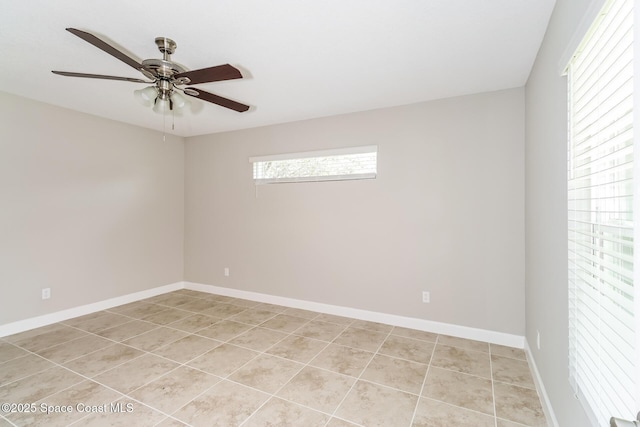 tiled spare room featuring ceiling fan