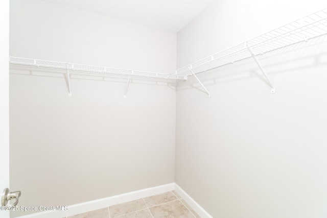 spacious closet featuring tile patterned flooring