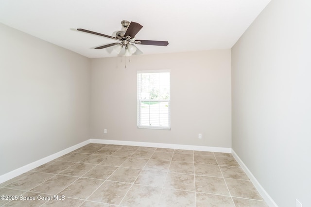 spare room featuring light tile patterned flooring and ceiling fan