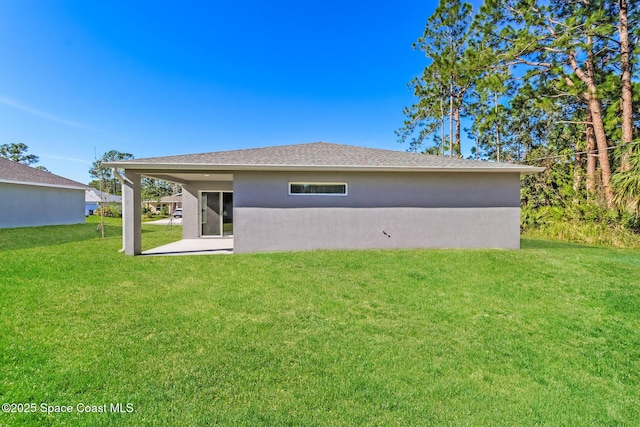 back of property featuring a yard and a patio area