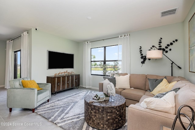 living room with light tile patterned flooring