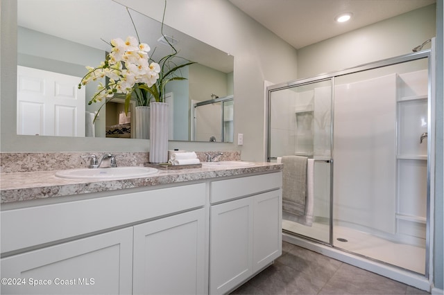 bathroom featuring vanity and a shower with shower door