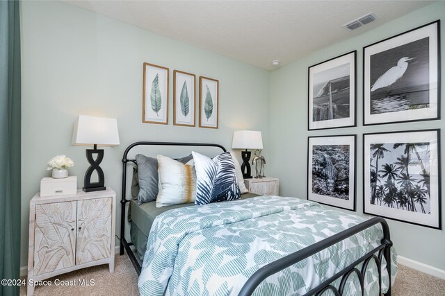 bedroom featuring light colored carpet