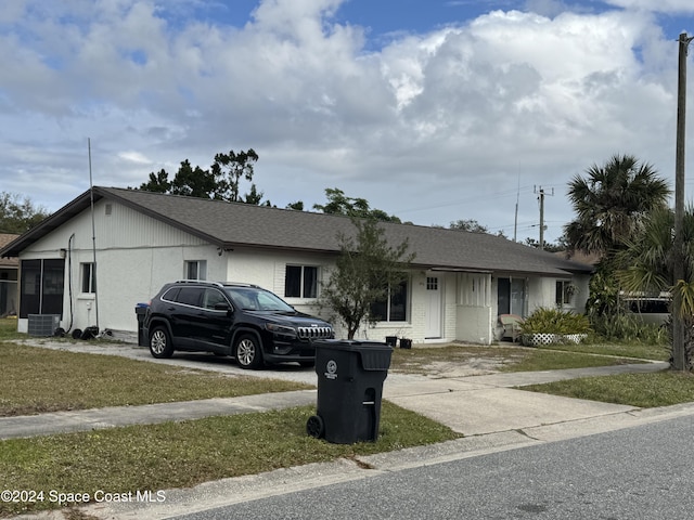 single story home with central AC and a front lawn