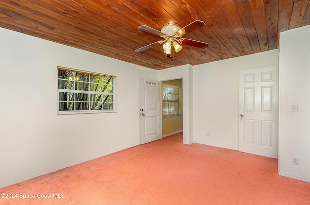 unfurnished room with wood ceiling, carpet floors, and ceiling fan