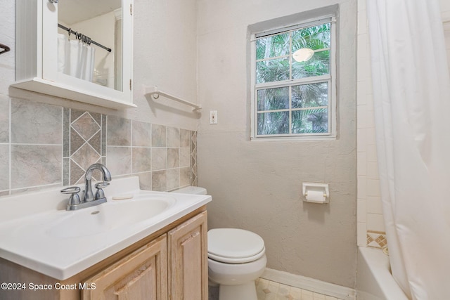 full bathroom with vanity, shower / tub combo, backsplash, and toilet