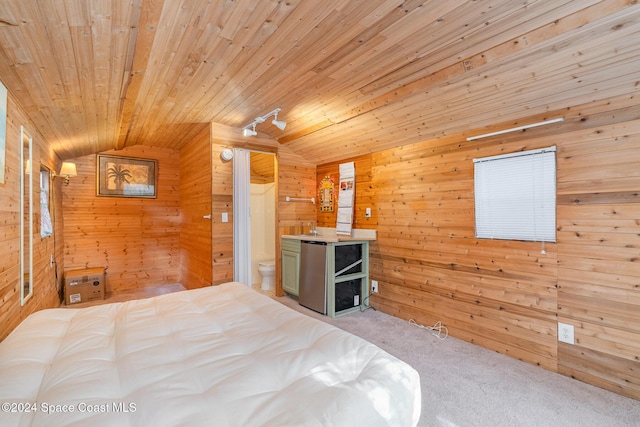 carpeted bedroom with lofted ceiling, ensuite bath, wooden ceiling, and wood walls