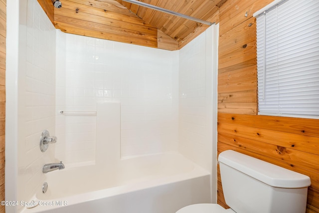 bathroom with toilet, tub / shower combination, vaulted ceiling, wooden ceiling, and wooden walls