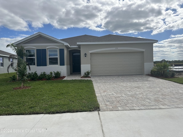 single story home with a front yard and a garage