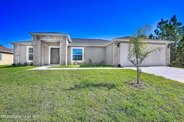 single story home featuring a garage and a front lawn