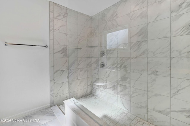 bathroom featuring a tile shower