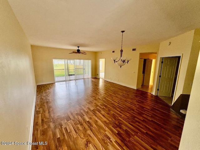 empty room featuring wood-type flooring and ceiling fan with notable chandelier