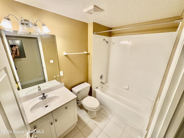 full bathroom featuring tile patterned flooring, a textured ceiling,  shower combination, toilet, and vanity