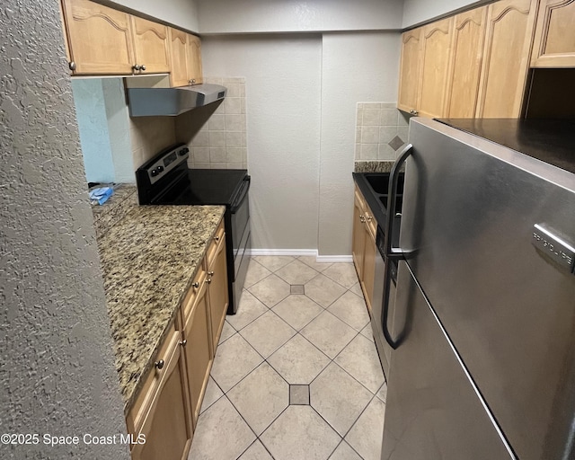 kitchen featuring extractor fan, dark stone countertops, light tile patterned floors, electric range, and stainless steel fridge