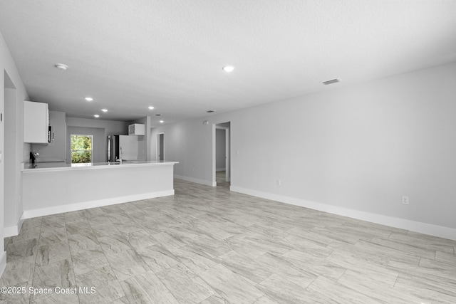 unfurnished living room featuring a textured ceiling