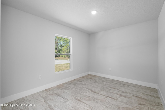 spare room featuring a textured ceiling